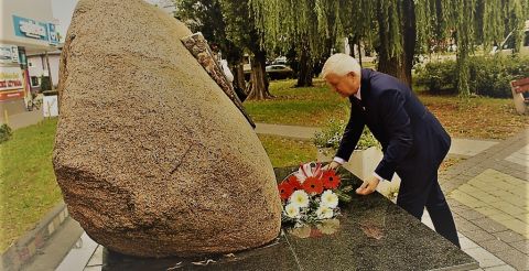 Moment składania kwiatów na pomniku przez Burmistrza miasta Hajnówka